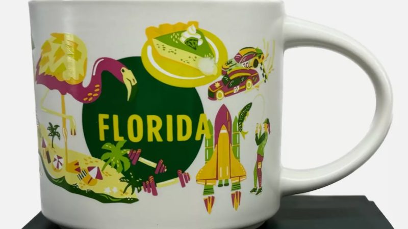 Florida Starbucks mug displaying a flamingo, key lime pie, race cars, space shuttle, and beach umbrellas.