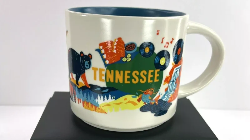 Tennessee Starbucks mug with illustrations of a black bear, guitar, vinyl records, and waterfall.