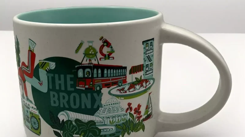 The Bronx Starbucks mug with images of a botanical garden, zoo, historic building, and music notes.