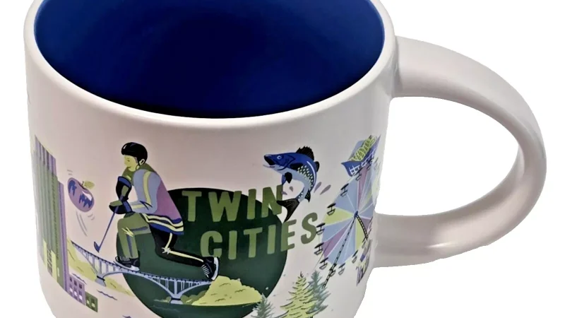 Twin Cities Starbucks mug with illustrations of a hockey player, Ferris wheel, pine trees, and city elements.