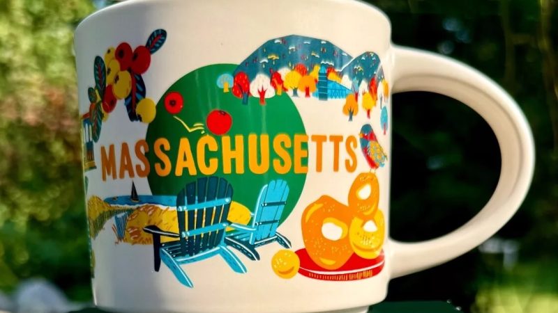 Massachusetts Starbucks mug displaying apples, Boston State House, Mayflower, and lobster.