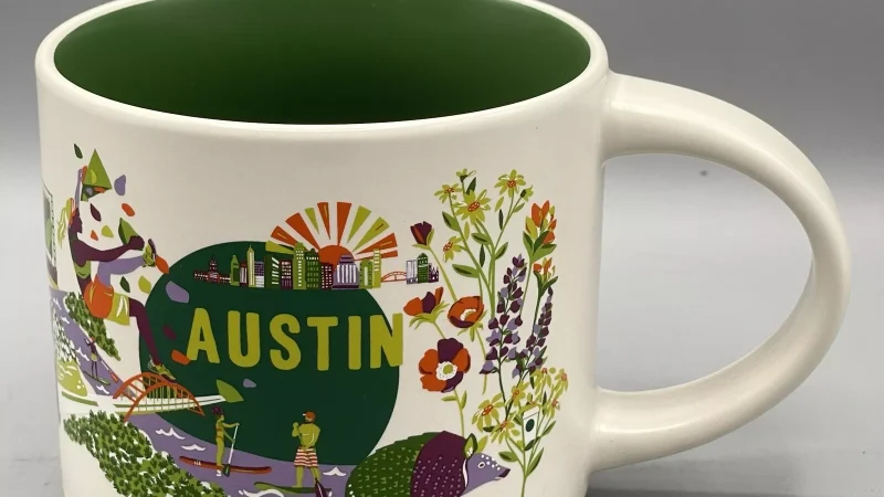 Austin Starbucks mug showing the city skyline, a colorful armadillo, paddleboarder, live music stage, and food truck against a bright design.