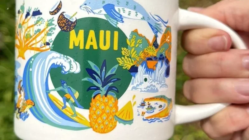 Maui Starbucks mug with a pineapple, surfer, marine life, volcano, and tropical flowers.