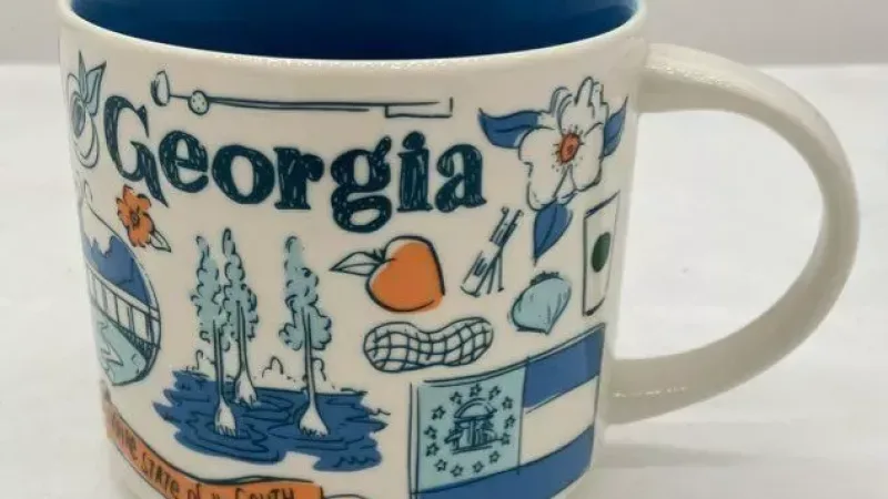 Front view of the Starbucks Been There Series Georgia mug, showcasing state symbols like the peach and state flag.