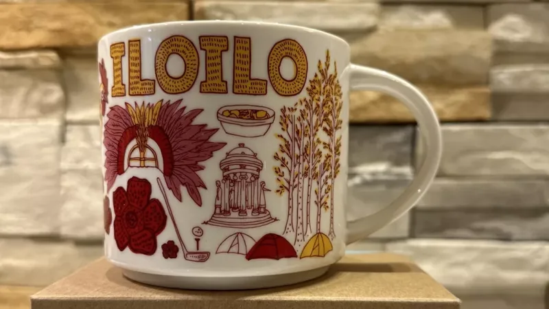 Front view of the Starbucks Been There Series Iloilo mug, featuring Dinagyang Festival mask and rice fields