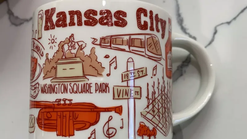 Front view of the Starbucks Been There Series Kansas City mug featuring jazz symbols, barbecue, and historic landmarks.